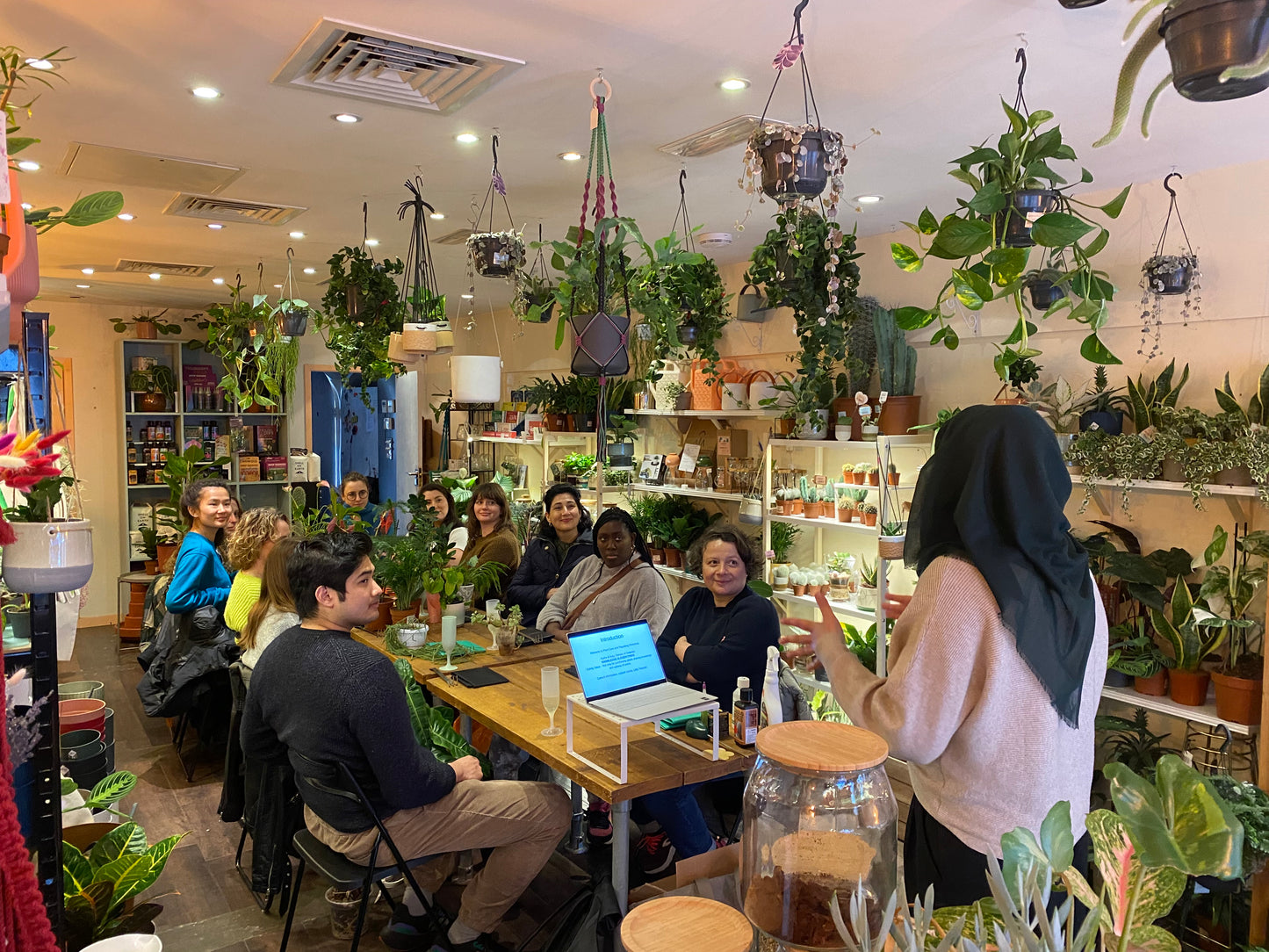 people sat around a table at a plant care workshop