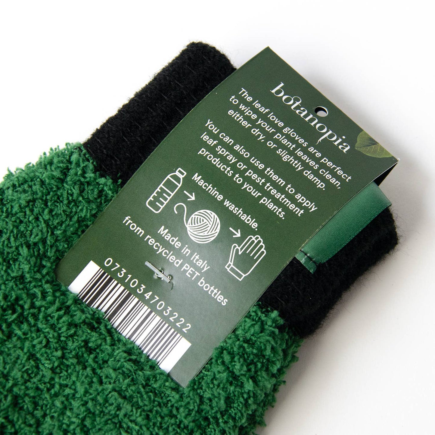 Green and black gloves with a Botanopia label on a white background