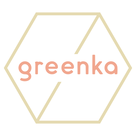Logo of greenka with pink text inside a gold hexagon on a white background