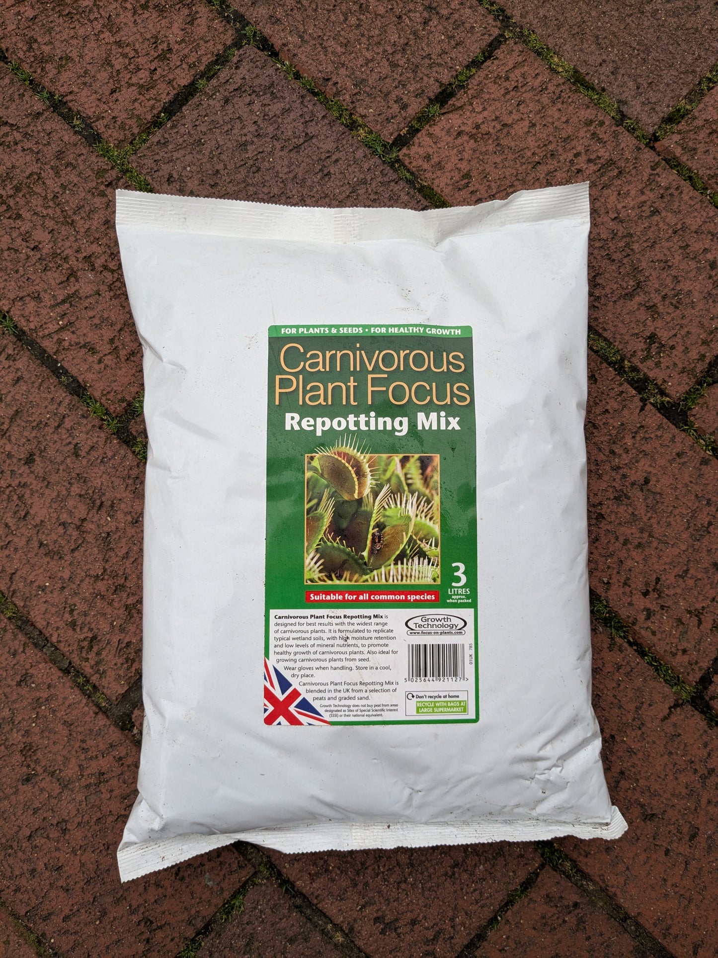 Bag of Carnivorous Plant Focus Repotting Mix on a brick surface