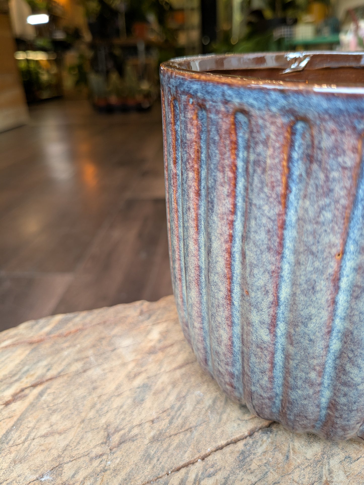 Ceramic cup with striped design on a wooden surface