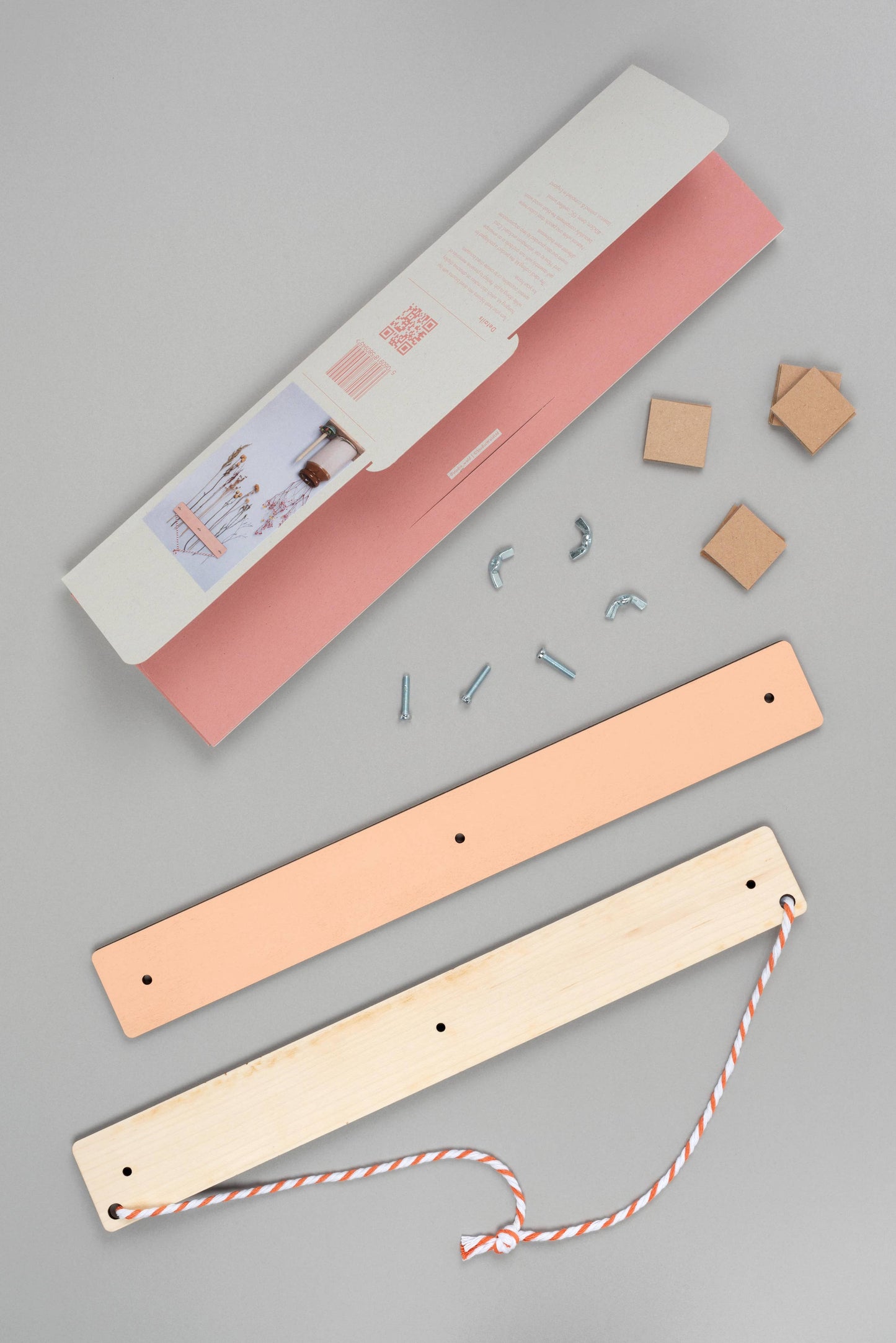 Wooden bookmarks with pink and beige covers on a gray background