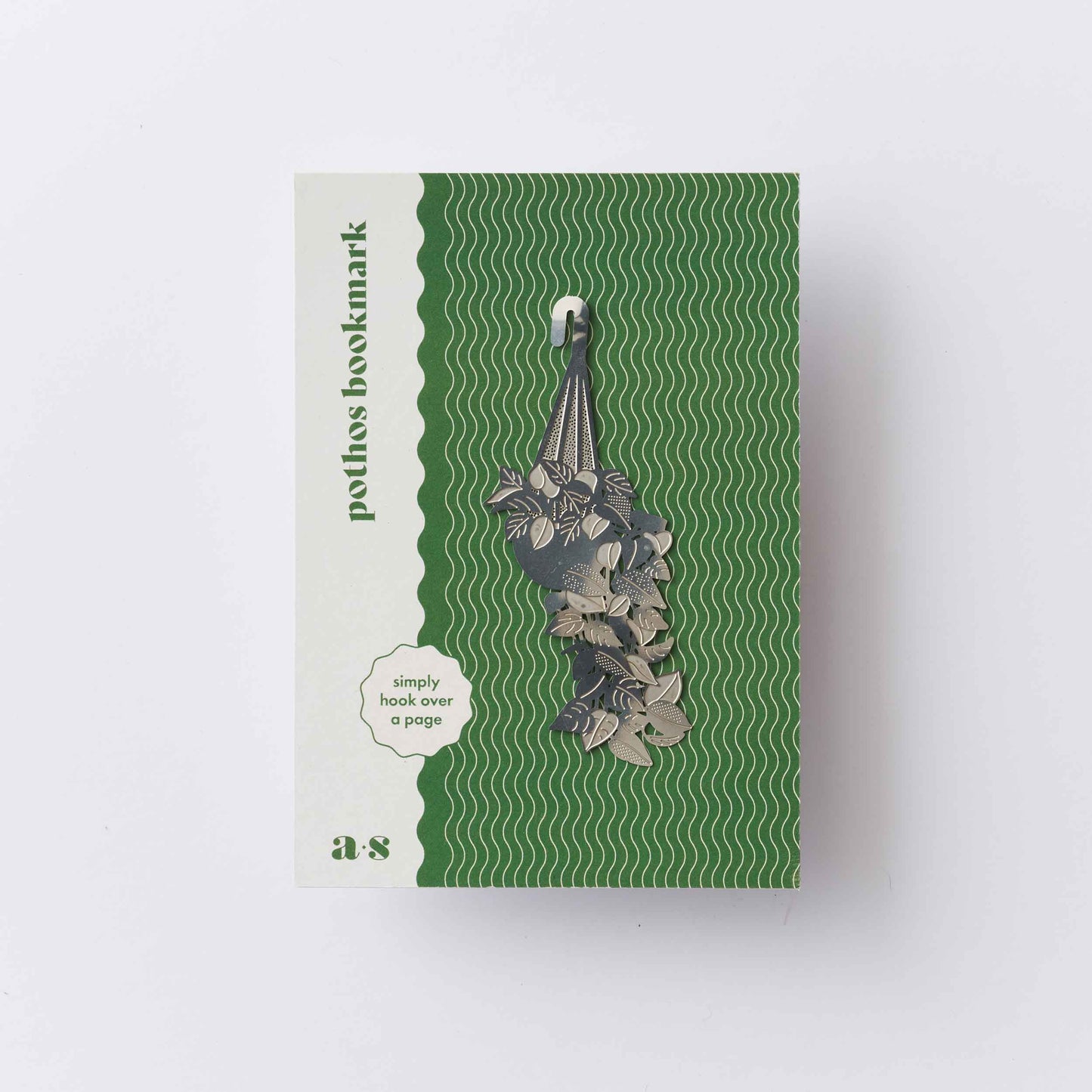 Green and beige packaging of a plant holder with text on a white background