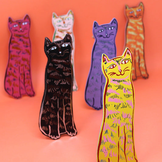 Colorful cat-shaped pins on an orange background