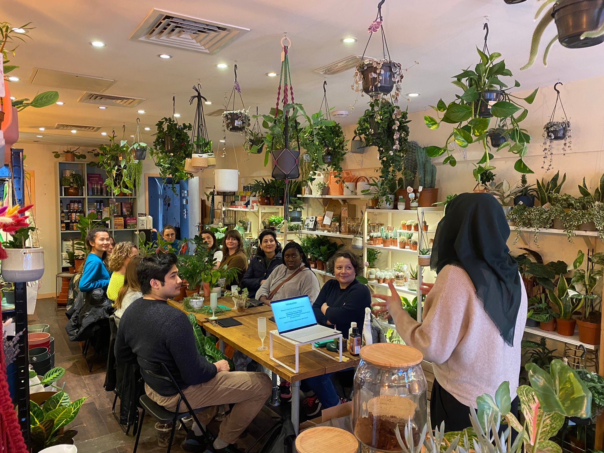 people sat around a table at a plant care workshop