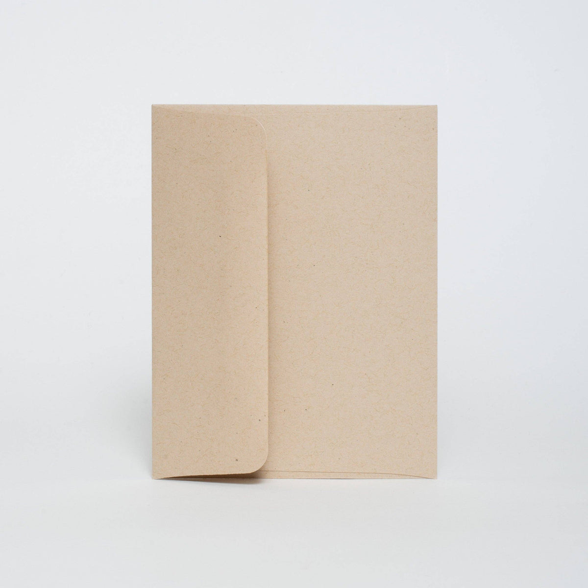 Two beige notebooks stacked on a white background