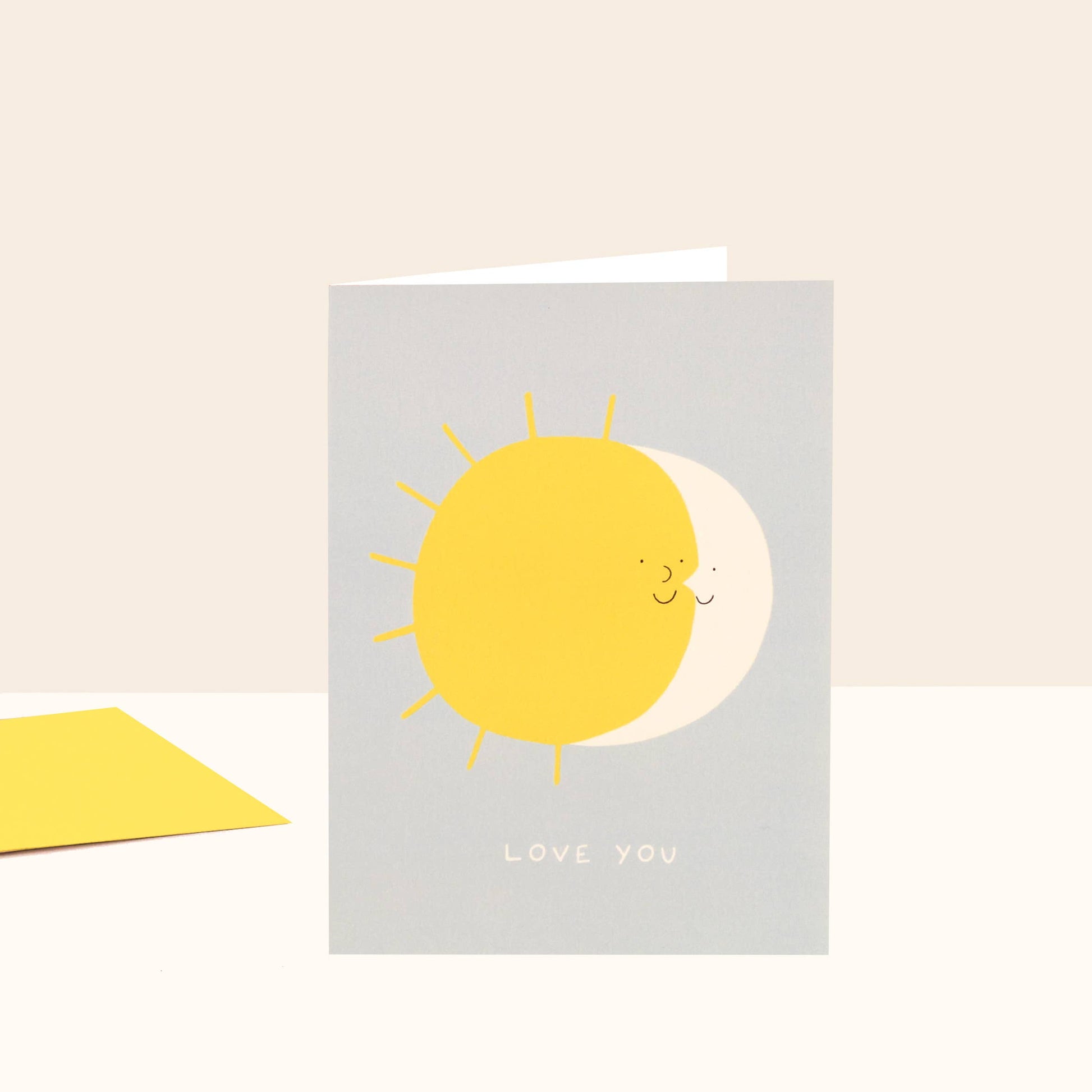 Card with yellow sun and moon illustration and 'LOVE YOU' text on a light gray background