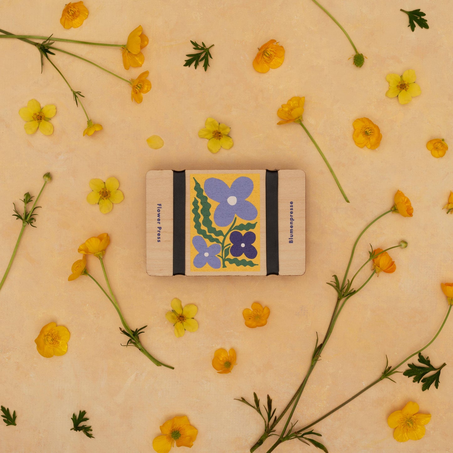 Notebook with floral design on a beige background with yellow flowers