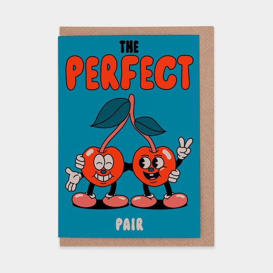 Greeting card with cartoon cherries and text 'The Perfect Pair' on a blue background