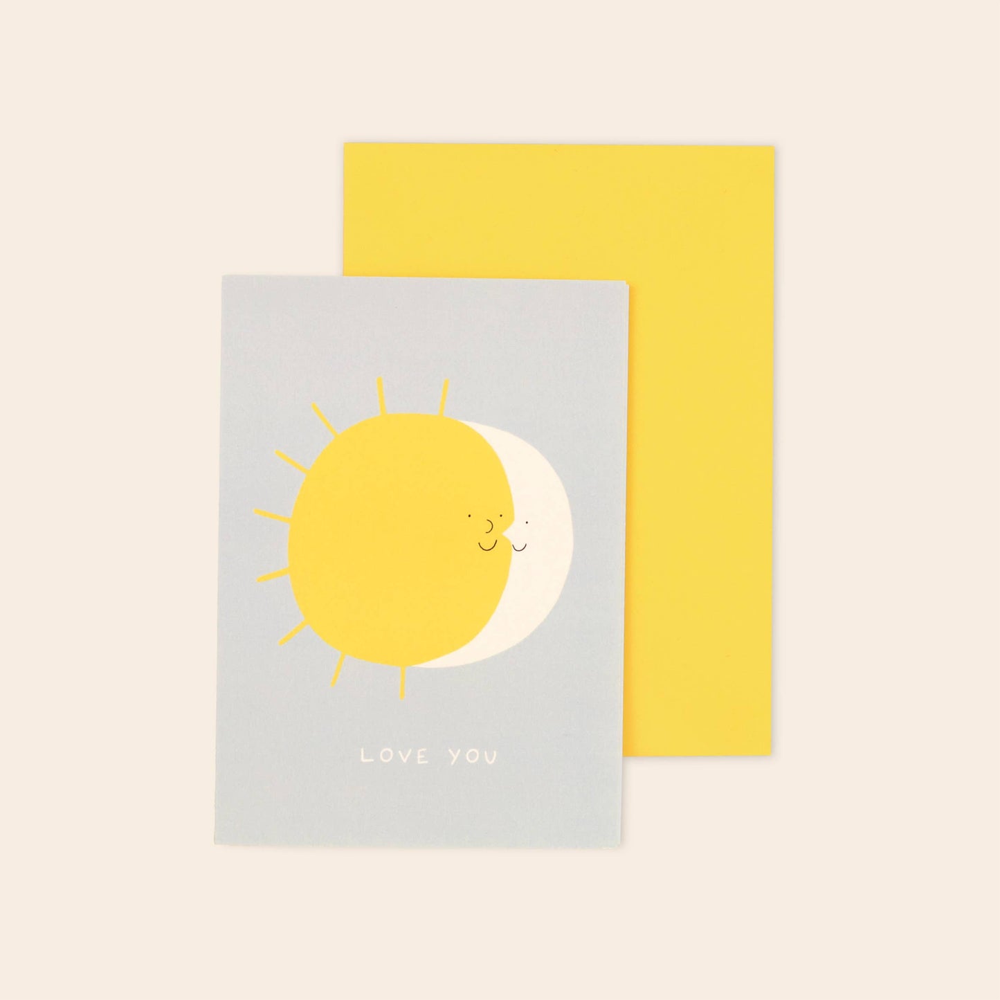 Two greeting cards with sun and moon design on a beige background
