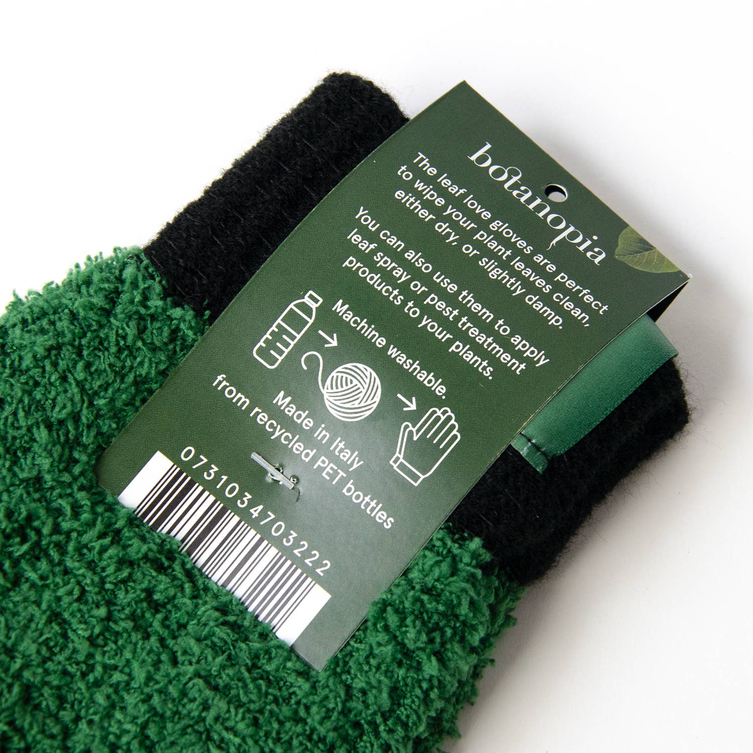 Green and black gloves with a Botanopia label on a white background