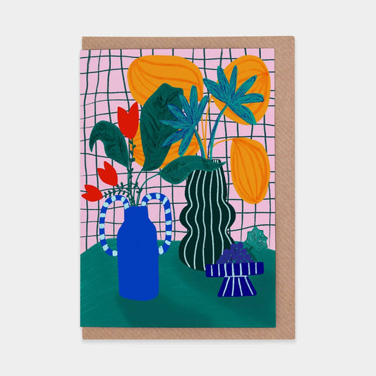 Greeting card with colorful plant illustration on a pink grid background