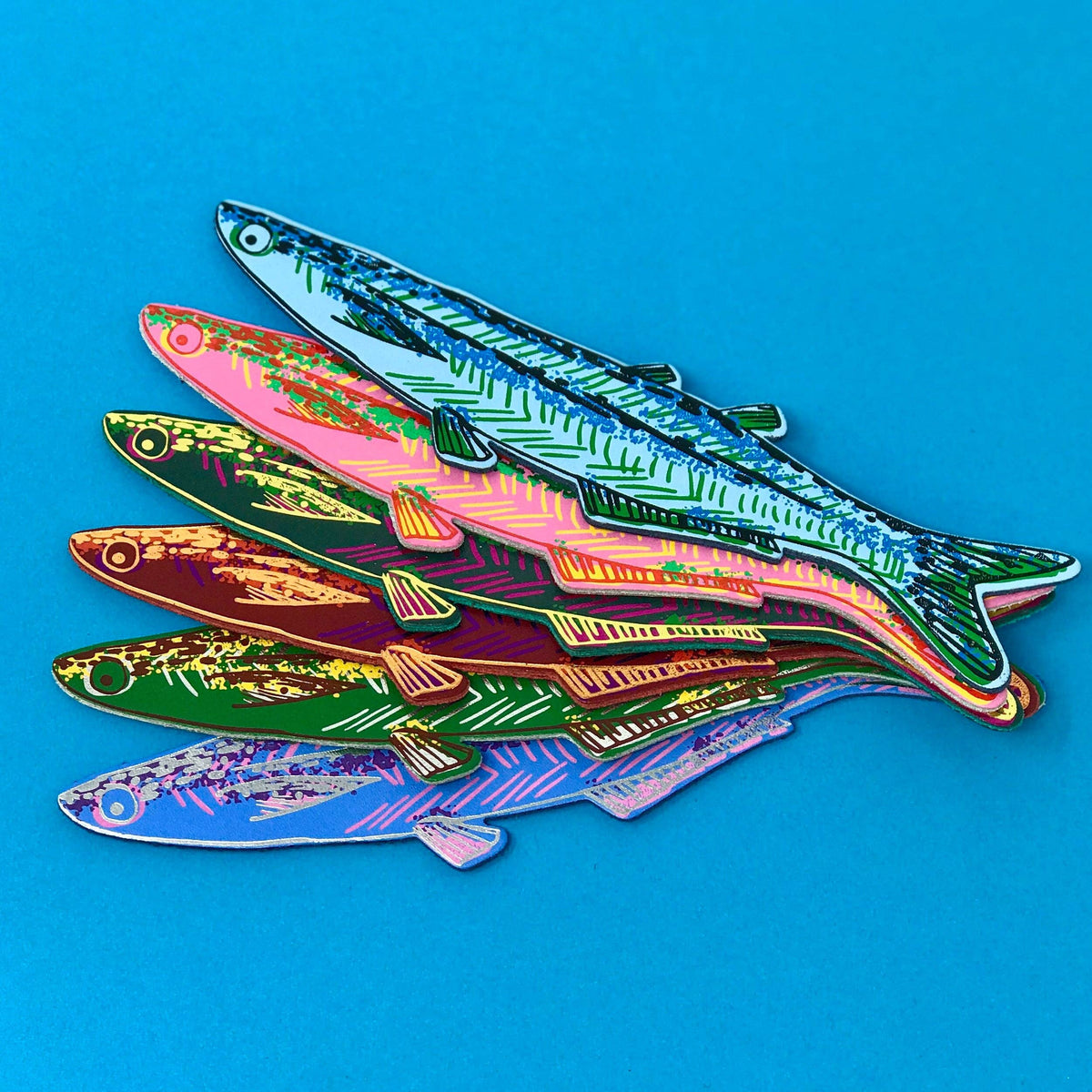 Colorful fish-shaped objects on a blue background