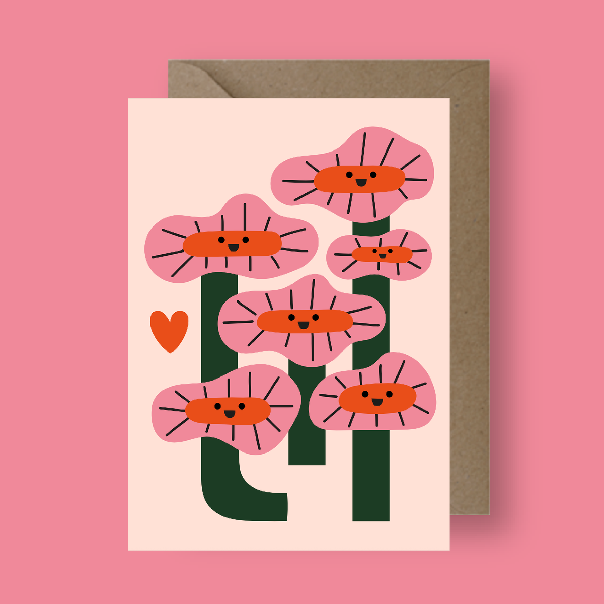 Greeting card with pink floral design and brown envelope on a pink background
