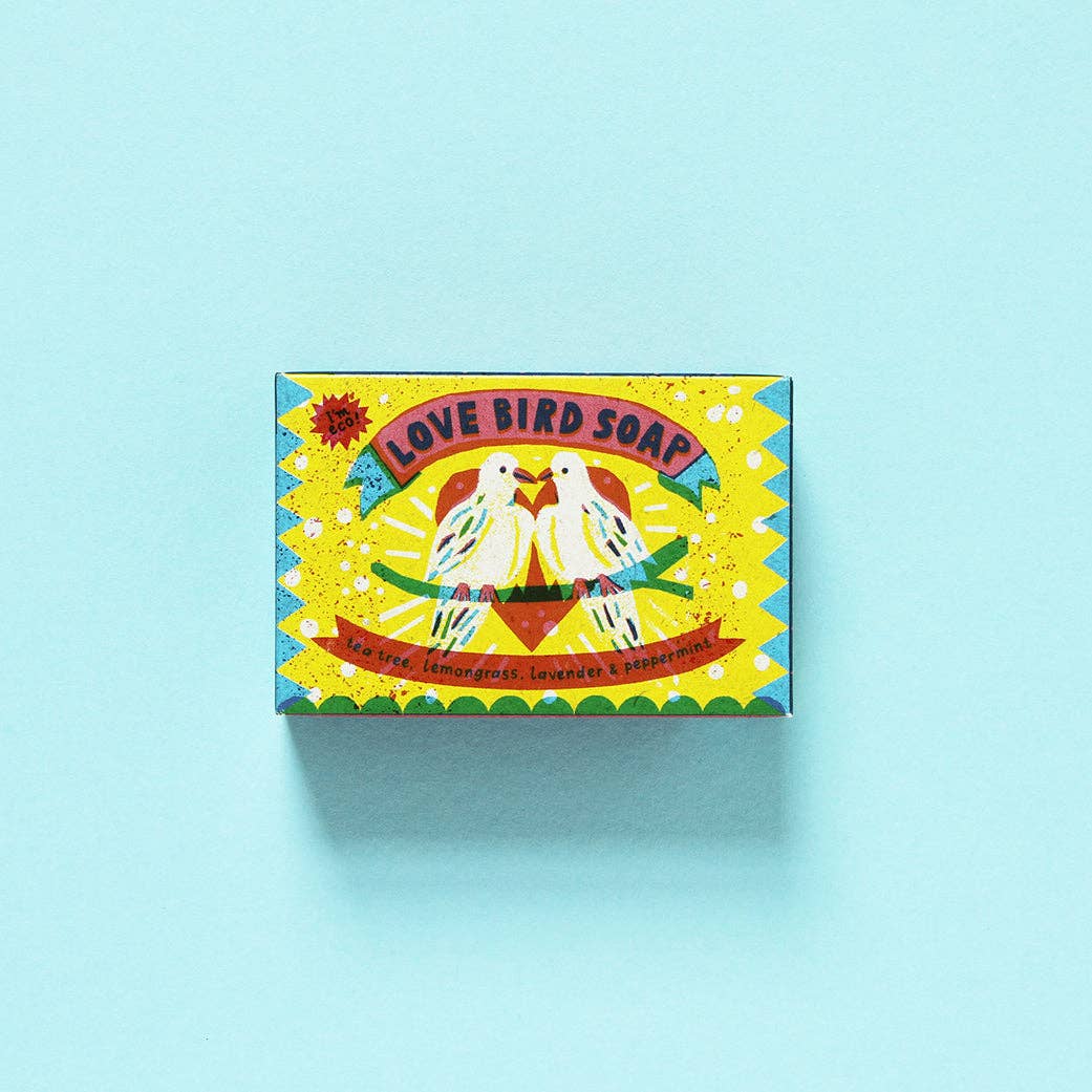 Colorful packaging of love bird soap on a light blue background