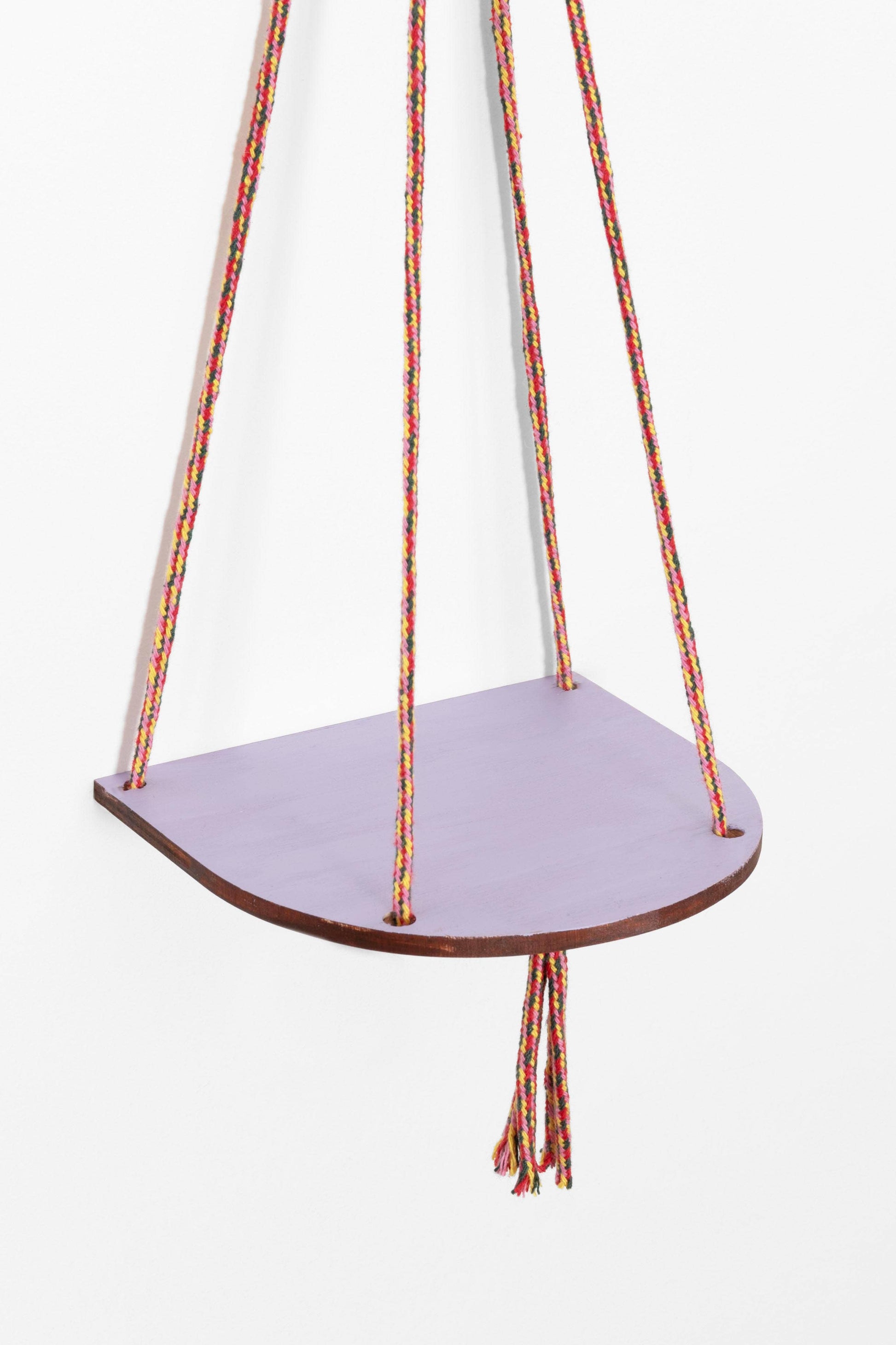 Hanging shelf with colorful ropes on a white background