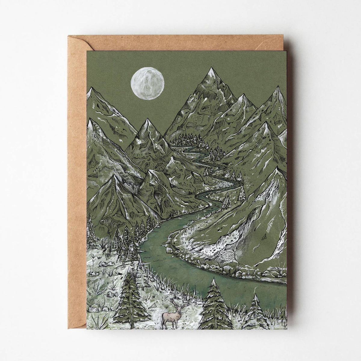 A square art print or card featuring a mountain landscape illustration with a winding river, trees, and a full moon, shown with a kraft envelope against a light neutral background.