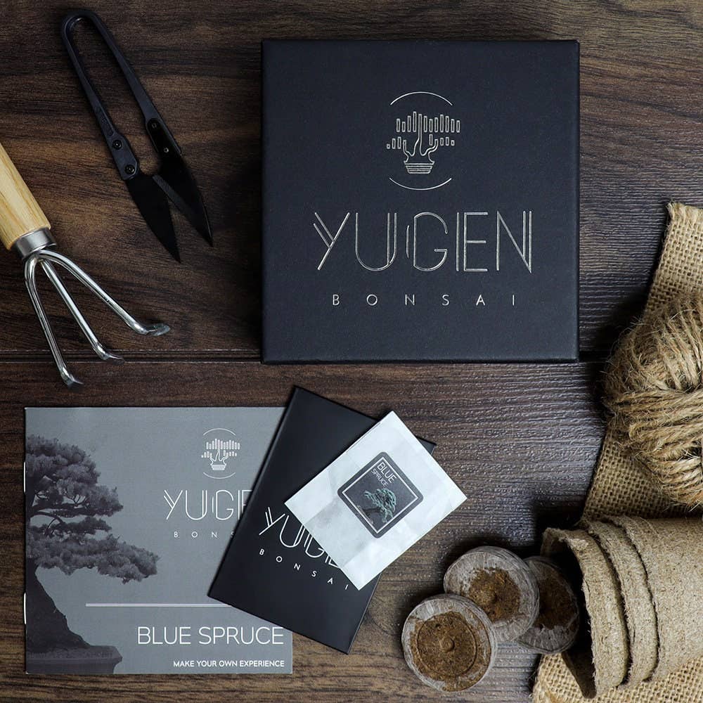 Yuigen Bonsai packaging and tools on a wooden surface
