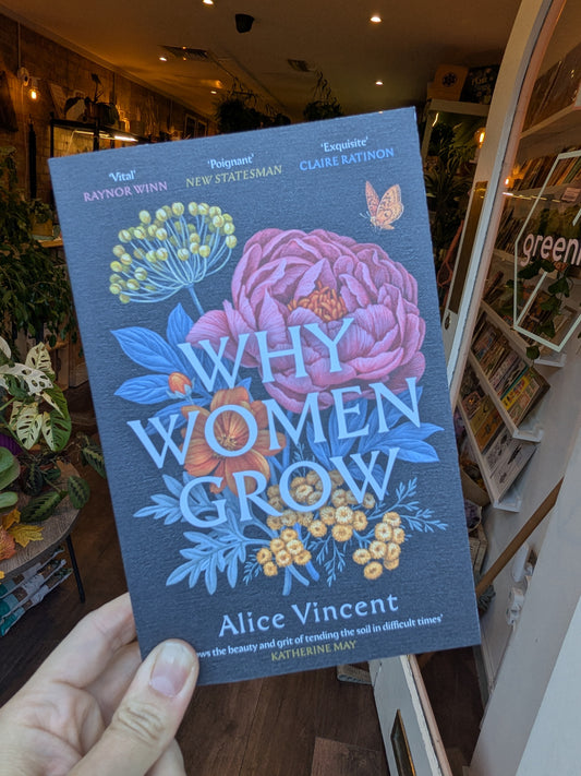 Book titled 'Why Women Grow' by Alice Vincent held in a hand with a store interior background.