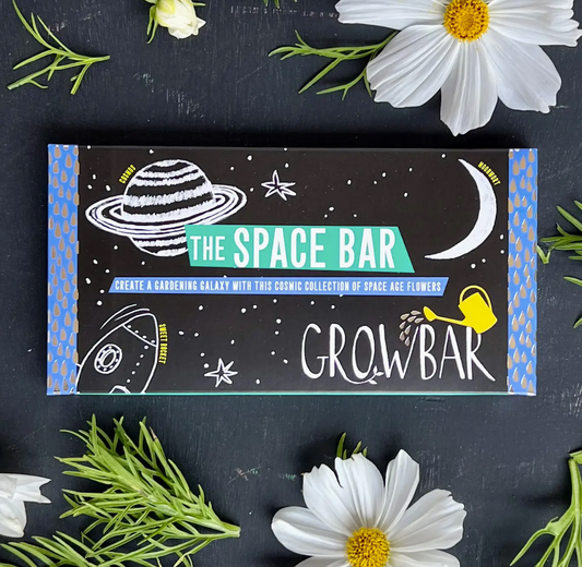 Space-themed gardening kit packaging with illustrations of celestial bodies on a dark background.