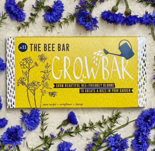 The Bee Bar Grow Bar packaging with blue flowers around it