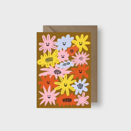 Greeting card with smiley face flowers on a brown background