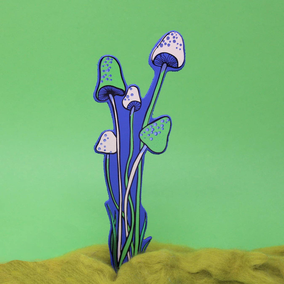 Colorful mushroom-shaped objects on a green background