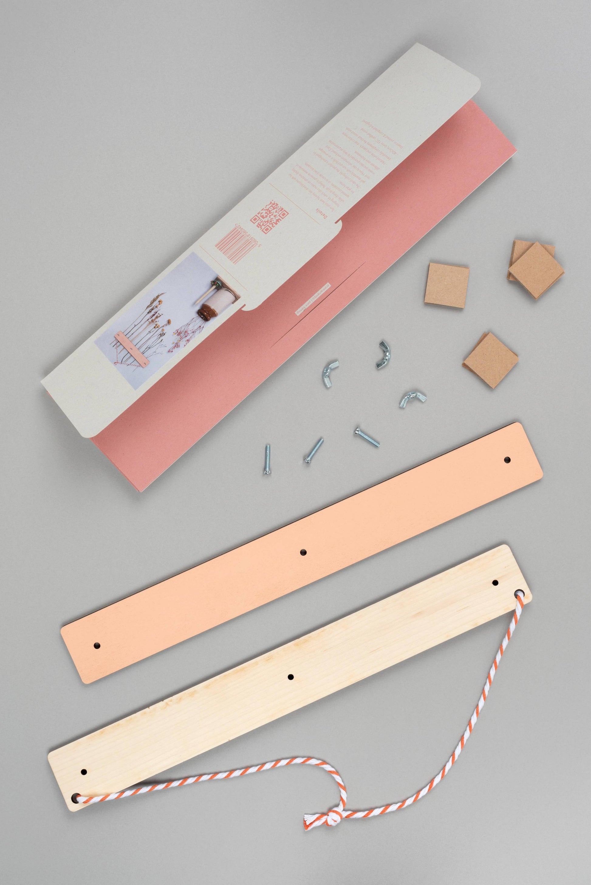 Wooden bookmarks with pink and beige covers on a gray background