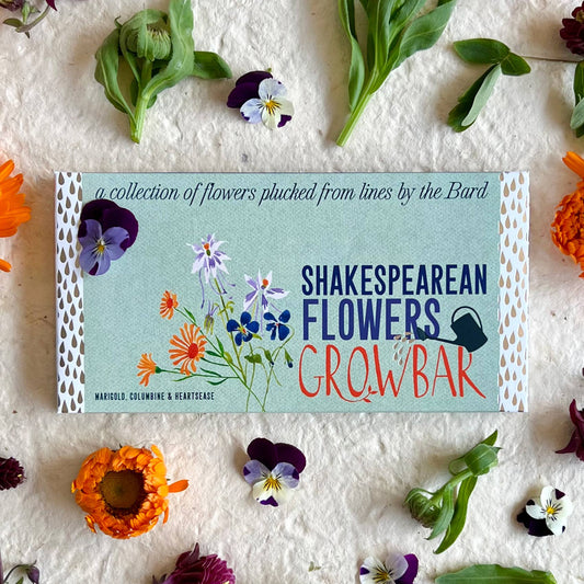 Shakespearean Flowers Grow Bar packaging with flowers around on a textured white background