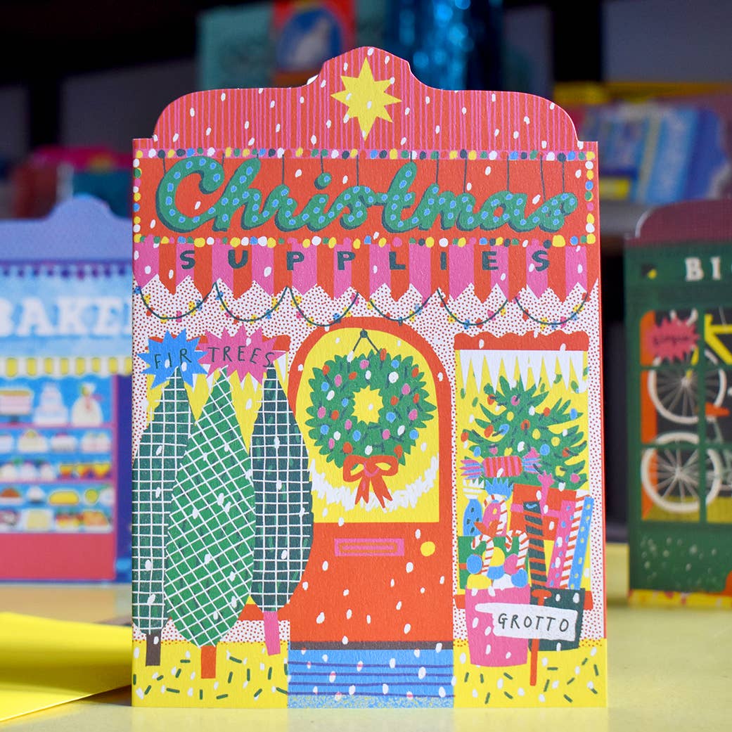 Colorful Christmas-themed packaging with festive illustrations on a blurred background