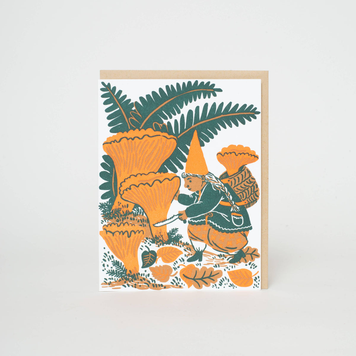 A vertical art print or card featuring a whimsical illustration of a fairy-like figure with a pointed hat among large orange mushrooms and dark green leaves, shown standing against a light neutral background.
