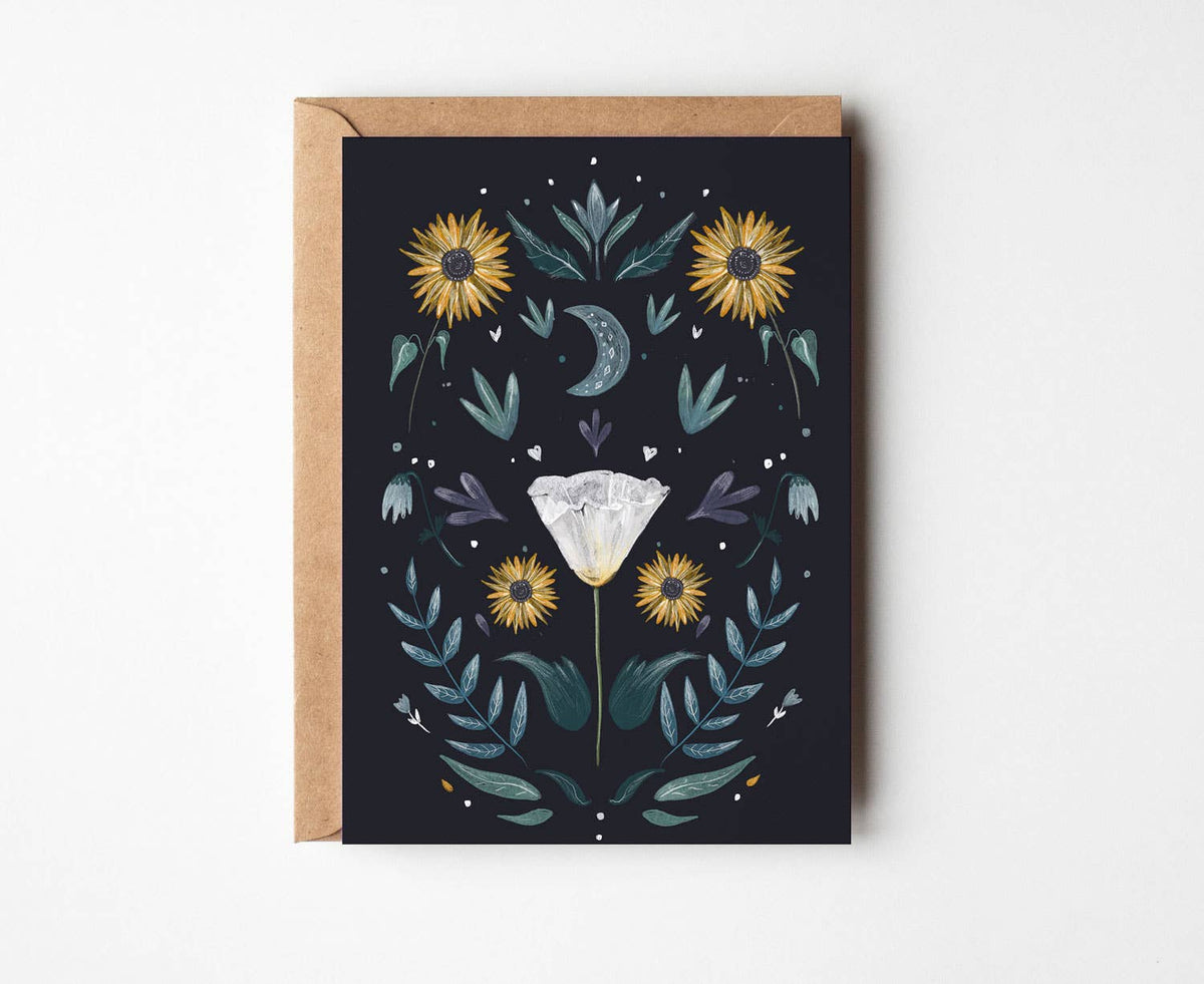 A square greeting card with a kraft envelope, featuring a dark navy background decorated with yellow sunflowers, teal leaves, a gray crescent moon, and a white diamond illustration in the center.
