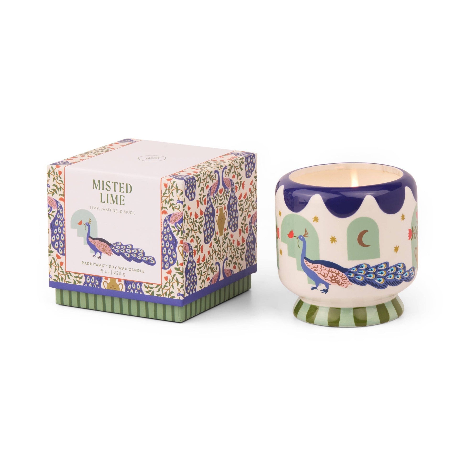 Decorative candle with peacock design and matching box on a white background