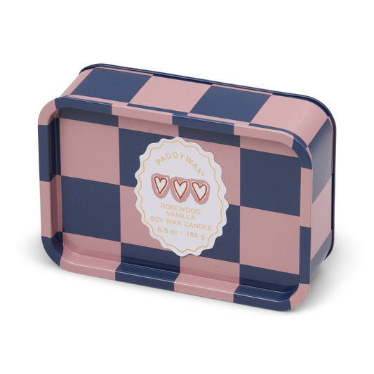 Pink and blue checkered tin with a label on a white background