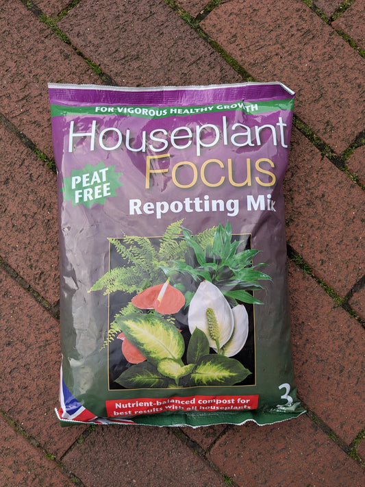 Bag of Houseplant Focus Repotting Mix on a brick surface